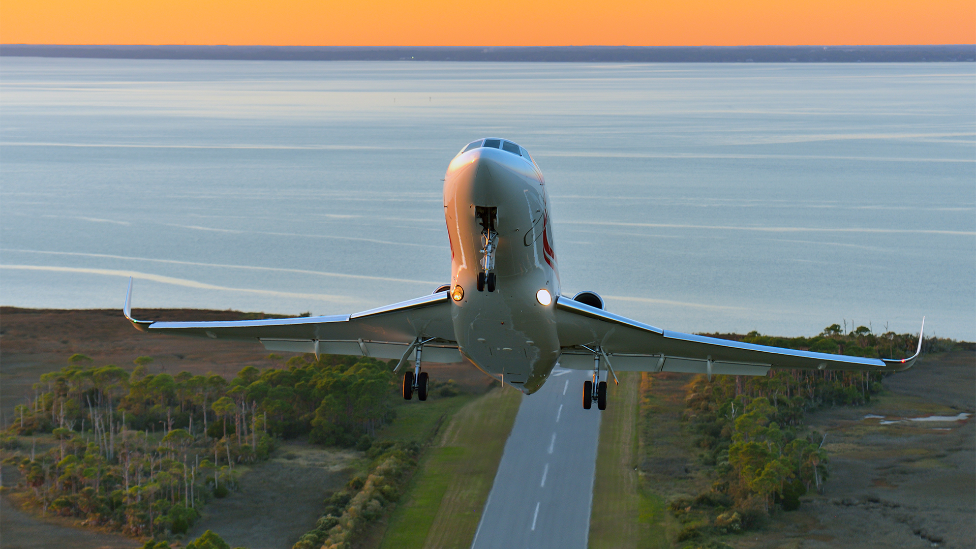 Falcon 900 is shown taking off from a runway at a steep incline.